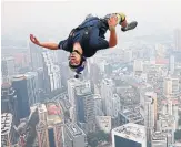  ?? VINCENT THIAN THE ASSOCIATED PRESS FILE PHOTO ?? Vince Reffet leaps from the 300-metre Open Deck of the Kuala Lumpur Tower in Malaysia in 2013.