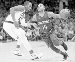  ?? TONY DEJAK/ASSOCIATED PRESS ?? Magic's D.J. Augustin, drives past the Cavaliers' JR Smith in Oct. 21 game, is still nursing a hamstring injury and likely won’t be playing on the Magic’s west coast trip.