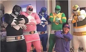  ?? COURTESY OF BRENT VENABLES ?? Clemson defensive coordinato­r Brent Venables kneels with his defensive linemen, who are dressed as Power Rangers.