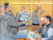  ?? PTI ?? Polling staff counts the votes of urban local body polls of J&amp;K for 52 civic bodies at a Counting Centre in Srinagar on Saturday.