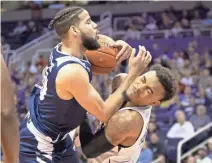  ??  ?? Nevada’s Caleb Martin, left, and Grand Canyon’s Carlos Johnson collide during the Jerry Colangelo Classic in Phoenix on Sunday.
