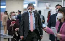  ?? J. SCOTT APPLEWHITE — THE ASSOCIATED PRESS FILE ?? In this Feb. 25, 2021, file photo, reporters question Sen. Joe Manchin, D-W.Va., as he arrives for votes on President Joe Biden’s cabinet nominees, at the Capitol in Washington.