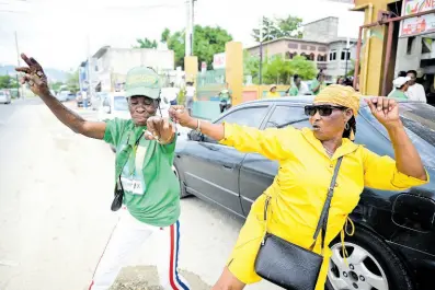  ?? GLADSTONE TAYLOR/MULTIMEDIA PHOTO EDITOR ?? Evadne Henry (left), dances off against Marvelous Marva during the local government elections on February 26.