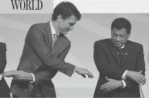  ?? ADRIAN WYLD / THE CANADIAN PRESS ?? Prime Minister Justin Trudeau shakes hands with Philippine President Rodrigo Duterte during an event at the ASEAN summit in Manila, Tuesday. Trudeau said he raised concerns about human rights abuses and extrajudic­ial killings in Duterte’s anti-drug...