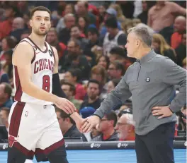  ?? JOHN J. KIM/CHICAGO TRIBUNE ?? Bulls guard Zach LaVine walks past coach Billy Donovan as he comes out of the game during the second quarter vs. the Magic on Friday at United Center.