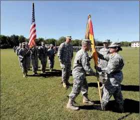  ?? NWA Media/J.T. Wampler ?? Brig. Gen. Patricia Anslow passes a banner to Col. Gregory Bacon at Saturday’s change of com
mand ceremony.