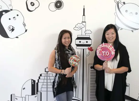  ?? ANDREW FRANCIS WALLACE/TORONTO STAR ?? Catherine Chan, left, and Jennifer Liu snapped up the first Canadian franchise of candy chain Papabubble, because they felt Toronto had nothing like it.