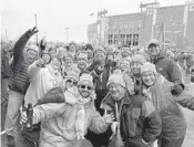  ?? SAFID DEEN/SUN SENTINEL ?? Dolphins fans Andy Gerivon, bottom left, and Kelsey Gerivon, bottom right, pose for a photo with friends before Sunday’s game at Lambeau Field.