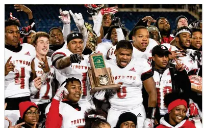  ??  ?? Trotwood-Madison twins Keon’tae (left) and Ke’Shawn Huguely (both holding trophy) celebrate the Rams’ third football state title. It’s not clear when high school athletes might get to train at school facilities again.