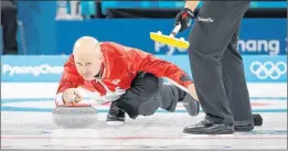  ?? AP PHOTO/NATACHA PISARENKO ?? Canada’s skip Kevin Koe throws a rock during a men’s curling match against Italy at the 2018 Winter Olympics in Gangneung, South Korea, Wednesday.