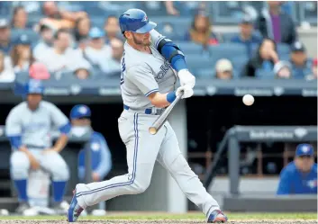  ?? JIM MCISAAC/GETTY IMAGES ?? Toronto Blue Jays slugger Josh Donaldson connects on an eighth inning run scoring sacrifice fly against the New York Yankees, at Yankee Stadium, on Saturday, in the Bronx borough of New York City.