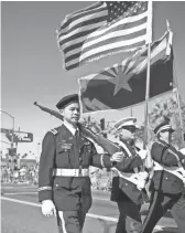  ?? BEN MOFFAT/THE REPUBLIC ?? An honor guard leads off the Veterans Day Parade in central Phoenix on Nov. 11, 2016.