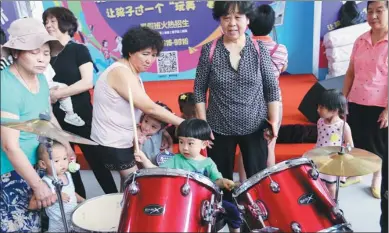  ?? WANG ZHUANGFEI/CHINA DAILY ?? A pint-size potential music star plays drums at the eighth Kids Fun Expo on Friday. The expo, open through Sunday at the Agricultur­al Exhibition Center in Beijing, includes thousands of toys from over 200 brands from across the world.