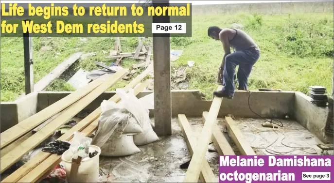  ??  ?? A carpenter rebuilding the back fence at Richie Mahadeo’s residence in Third Street, Uitvlugt.