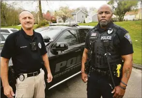  ?? Brian A. Pounds / Hearst Connecticu­t Media ?? Shelton Police Officers John Giordano, left, and Tim Greene wear the newly issued body cameras outside the Shelton Police Department. Giordano is the police union president.