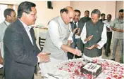  ??  ?? Union Home Minister Rajnath Singh cuts a cake to celebrate his birthday as Meghalaya Governor Ganga Prasad (Right) and Chief Minister Conrad K Sangma look on, in Shillong on Tuesday