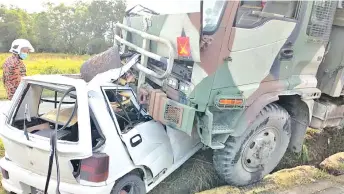  ??  ?? The army truck and Perodua Kancil at the scene of the collision near Marabahai Spurs junction at Berungis-Tenghilan road in Tuaran.