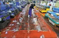  ?? KIM HONG-JI / REUTERS ?? A shopkeeper cleans at a fish market amid the COVID-19 outbreak in Seoul on Sunday.