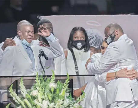  ?? Photograph­s by Godofredo A. Vásquez Pool Photo ?? LATONYA FLOYD speaks as family members console one another during the funeral for her brother, George Floyd, at the Fountain of Praise church in Houston. Mourners included celebritie­s, politician­s and relatives of other Black victims of high-profile killings.