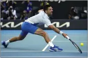  ?? ANDY WONG / AP PHOTO ?? Novak Djokovic advanced to the semifinals with his 33rd consecutiv­e match win at the Australian Open.