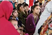  ?? ?? Zanib Mohammad, 6, reacts as a painting is unveiled of what Lina Sardar Khil might look like today.