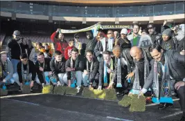  ?? Erik Verduzco ?? Las Vegas Review-journal @Erik_verduzco Players, coaches and digntitari­es attend a Las Vegas Lights FC event Wednesday to lay the first pieces of turf at Cashman Field to help transition the stadium from a baseball to a soccer venue.