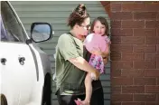  ?? TAMATI SMITH Getty Images ?? Cleo Smith is carried by her mother Thursday in Carnarvon, Australia, a day after the 4-year-old was found after police raided a house. A 36-year-old man has been arrested in connection with the abduction.
