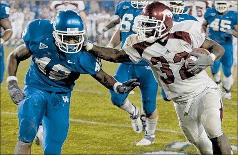  ?? Democrat-Gazette file photo ?? Arkansas’ DeCori Birmingham (right) scored on a 25-yard touchdown run to put the Razorbacks ahead in the seventh overtime against Kentucky on Nov. 1, 2003, in Lexington, Ky. Birmingham rushed for 196 yards and 2 touchdowns on 40 carries to help...