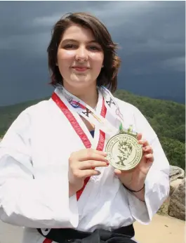  ??  ?? Lexi Hampo, 16, of Hot Springs, demonstrat­es a kick. Hampo recently won a gold medal in Coventry, England, in the Tae Kwon Do World Championsh­ips.