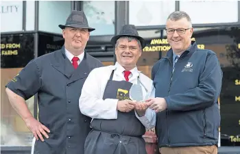  ?? ?? ACCOLADE: Mark Boyd proudly shows off his award with shop owner Bryan Beveridge, left, and Gordon King, executive manager of Scottish Craft Butchers.