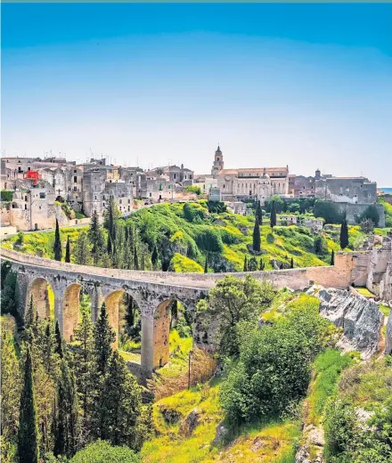 ??  ?? Soak in the sights of Puglia, such as the ancient bridge in Gravina, main pic, before retiring to the Castello Di Ungento, left, to dine and relax in its beautiful grounds