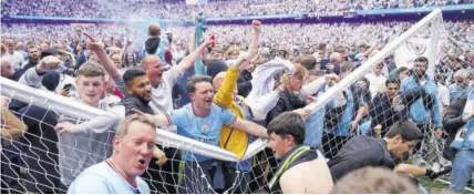  ?? (Photo: AP) ?? Manchester City fans celebrate winning the Premier League title after their match against Aston Villa at the Etihad Stadium in Manchester, England, on Sunday, May 22, 2022.