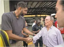  ?? MICHAEL NAGLE/ BLOOMBERG ?? Michael Bloomberg joins former NBA star Tim Duncan in St. Thomas for the launch of the hurricane recovery site usvi recovery .org.