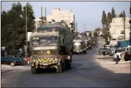  ?? (AP/Ghaith Alsayed) ?? A Turkish military convoy drives Tuesday through the village of Urum al-Jawz in Idlib province, Syria.