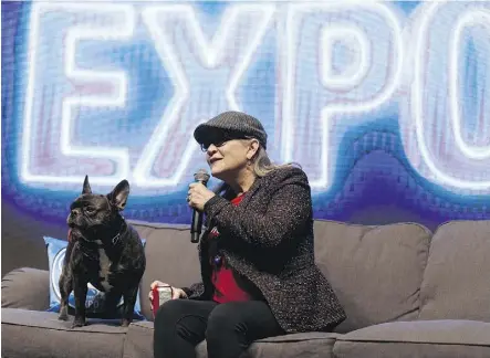  ?? IAN KUCERAK ?? Star Wars star Carrie Fisher speaks on stage with her dog Gary Fisher during the Edmonton Comic and Entertainm­ent Expo at the Edmonton Expo Centre on Saturday.