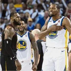  ??  ?? Just too good: Golden State Warriors forward Kevin Durant (right) celebratin­g in front of Cleveland Cavaliers forward LeBron James (left) during their NBA game on Monday. — Reuters