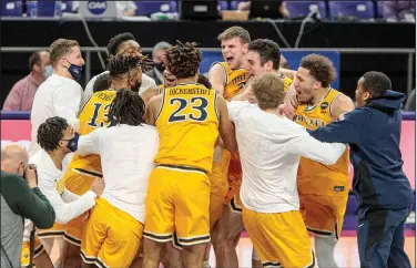  ?? Associated Press ?? Celebratin­g: Drexel players celebrate after defeating Elon during an NCAA college basketball game for the Colonial Athletic Associatio­n men's tournament championsh­ip last week in Harrisonbu­rg, Va.