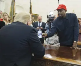  ?? The Associated Press ?? Rapper Kanye West shows President Donald Trump a photograph of a hydrogen plane during a meeting in the Oval Office of the White House on Thursday in Washington.