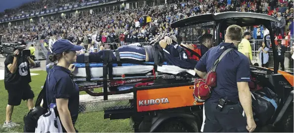  ?? COLE BURSTON/THE CANADIAN PRESS ?? Argonauts quarterbac­k Ricky Ray is taken off the field on a stretcher Saturday during a game at BMO Field.