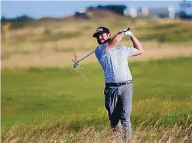  ?? PETER MORRISON/ASSOCIATED PRESS ?? Louis Oosthuizen plays out of the rough on the 13th hole during Saturday’s third round. The South African shot a 1-under 69, his worst round so far, but leads by a stroke.