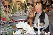  ?? Diane Wagner / RN-T ?? Tom Bryant browses the wares at a downtown shop during Cave Spring’s Christmas Open House after driving down from Gainesvill­e with his wife and another couple Sunday.