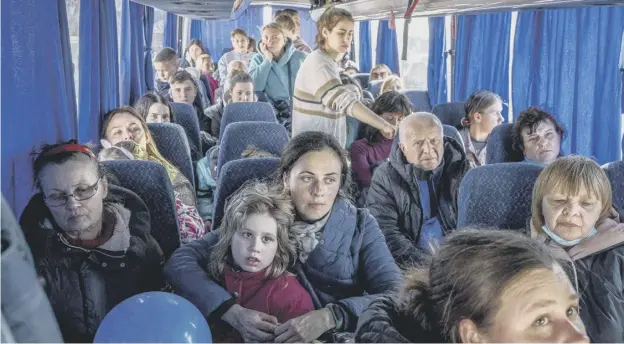  ?? ?? 0 Ukrainian evacuees on a bus carrying refugees after crossing the Ukrainian border with Poland at the Medyka border crossing