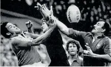  ??  ?? John Kirwan, centre, contests a high ball during the 1986 series against France where the so-called Baby Blacks pulled off a shock victory.