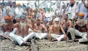  ?? PTI ?? Farmers shout slogans as they block railway tracks during a protest against the central government in Amritsar