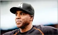  ?? AP PHOTO BY CARLOS OSORIO ?? In this 2016 photo, Miami Marlins hitting coach Barry Bonds looks from the dugout during the first inning of a baseball game against the Detroit Tigers in Detroit.