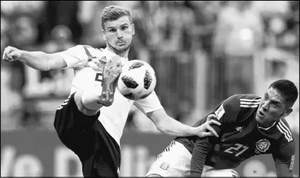  ?? AP PHOTO ?? Germany’s Timo Werner, left, controls the ball against Mexico’s Edson Alvarez during the group F match between Germany and Mexico at the 2018 soccer World Cup in the Luzhniki Stadium in Moscow, Russia, Sunday.