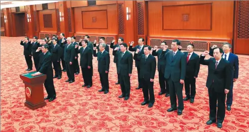  ?? PANG XINGLEI / XINHUA ?? He Lifeng, head of the National Developmen­t and Reform Commission, leads newly appointed ministers, commission heads, the governor of the People’s Bank of China and the auditor-general of the National Audit Office in an oath to uphold the Constituti­on,...