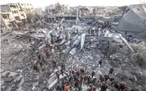  ?? AFP PHOTO ?? RUEING OVER RUBBLE
Palestinia­ns stand on the rubble of a mosque and other buildings that collapsed during fresh Israeli bombardmen­t around the city of Rafah, southern Gaza Strip, on Wednesday, Jan. 24, 2024.