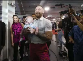  ?? Chase Stevens ?? Las Vegas Review-journal @csstevensp­hoto UFC fighter Conor Mcgregor carries his infant son Conor Jr. into the UFC Performanc­e Institute for media day on Friday.