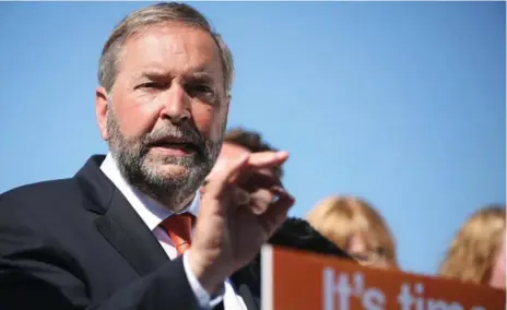  ?? COLE BURSTON/TORONTO STAR ?? NDP Leader Tom Mulcair criticized Employment Minister Pierre Poilievre for his partisan attire at what was billed as a government announceme­nt.